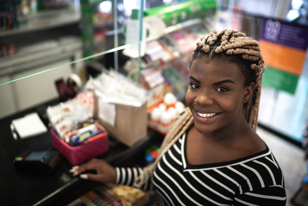 Retailer smiling at her register