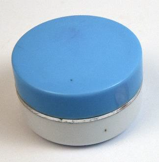 small round container of face cream with a blue cap and white body