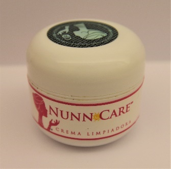 A small container of cream with a white cap and white body with the words  Nunn care in pink on the label