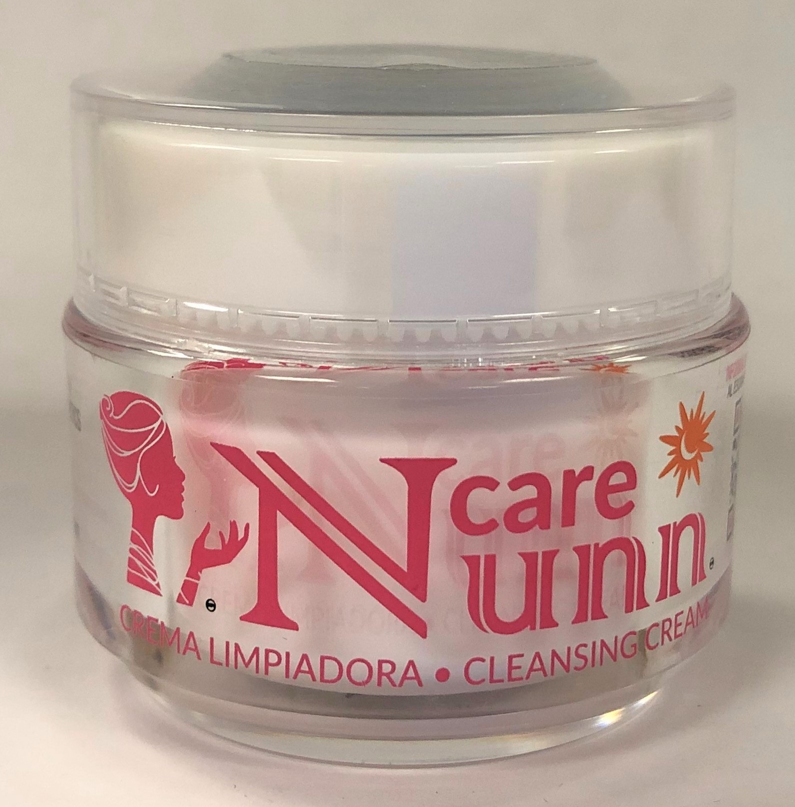 A small container of cream with a white cap and clear body with the words  Nunn care in pink on the label