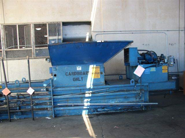 A large blue metal machine says Cardboard Only on one side.