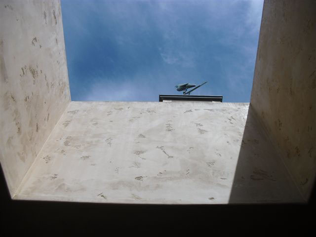 Roof opening seen from below. Directly adjacent to opening is the weathervane the worker went to check before falling through the opening.