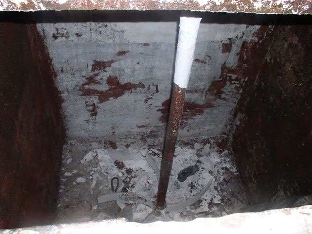 A view inside the tank shows a long pole in the middle with stirring blades at the bottom and the black shoe of one of the recovered workers.