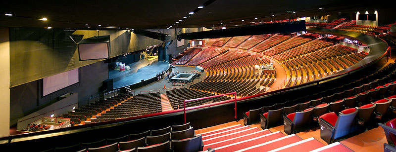 The inside of the amphitheatre showing the large seating area, the high ceiling, and the stage far below.