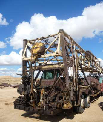The front of the rig is dirty and has a large movable device to attach to the rig.