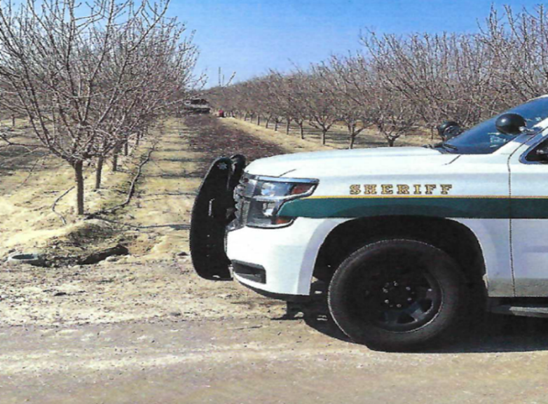 Sheriff vehicle at the almond field where the incident occurred