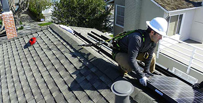 Solar panel worker on a household roof