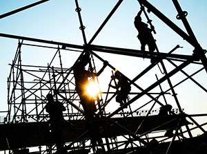 Construction workers on the frame of a building