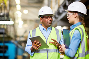 Male and female worker talking in warehouse