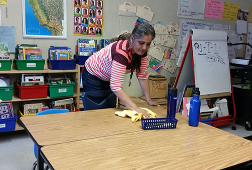 woman cleaning classroom