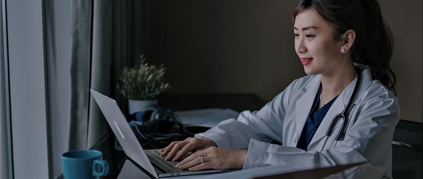 Healthcare provider using a laptop