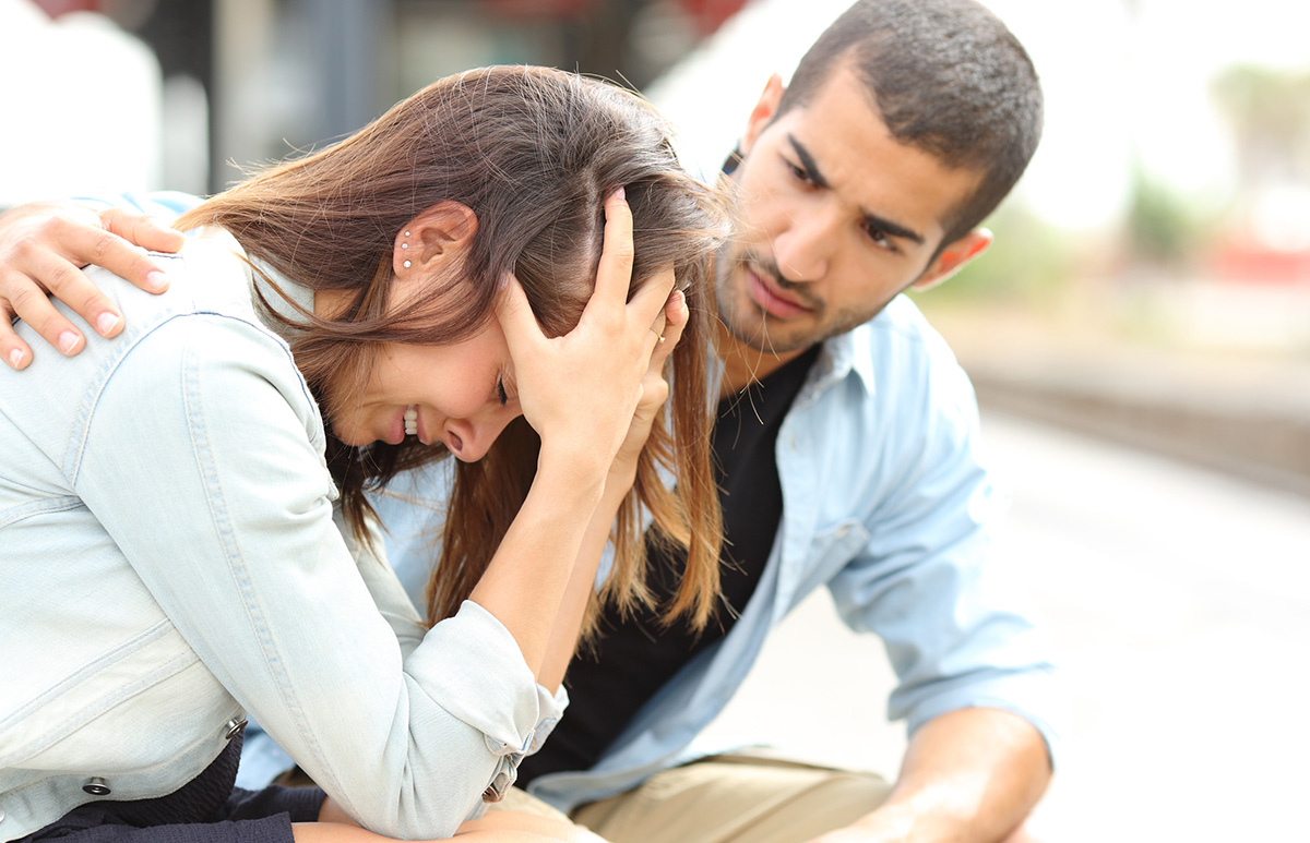 Man Consoling a Stressed Woman